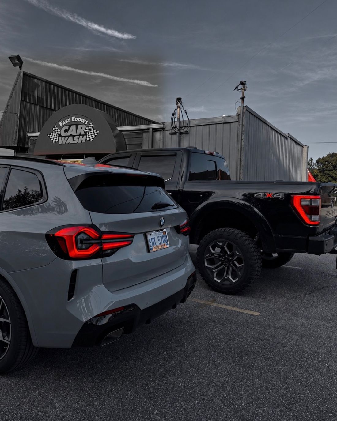Nick's gray BMW and black Ford F150 parked side by side