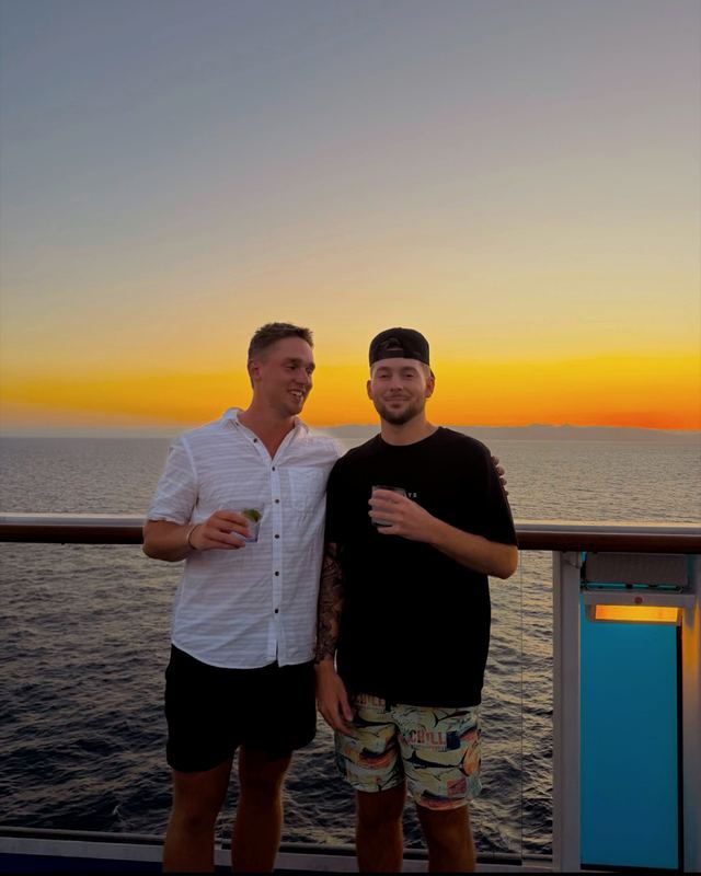 Nick and a friend on a cruise ship deck at sunset in Ensenada, Mexico