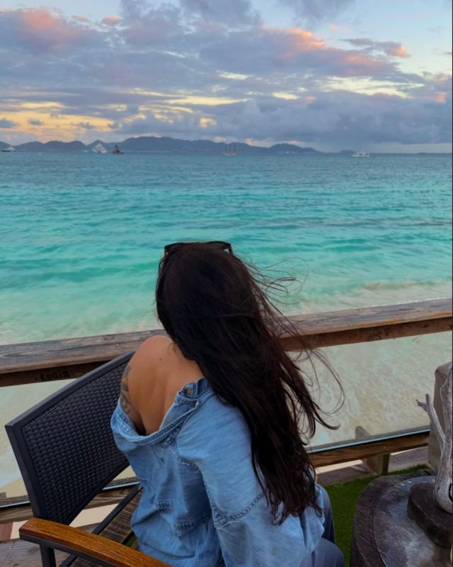 Nick's fiancée looking out over turquoise water at dusk in Anguilla