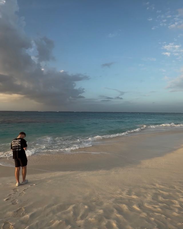 Nick standing on a beach at golden hour in Anguilla